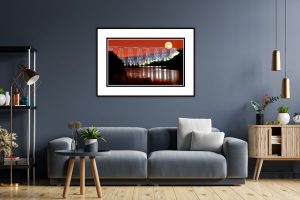 Bridge at Night with Moon Matted Print on a living-room wall