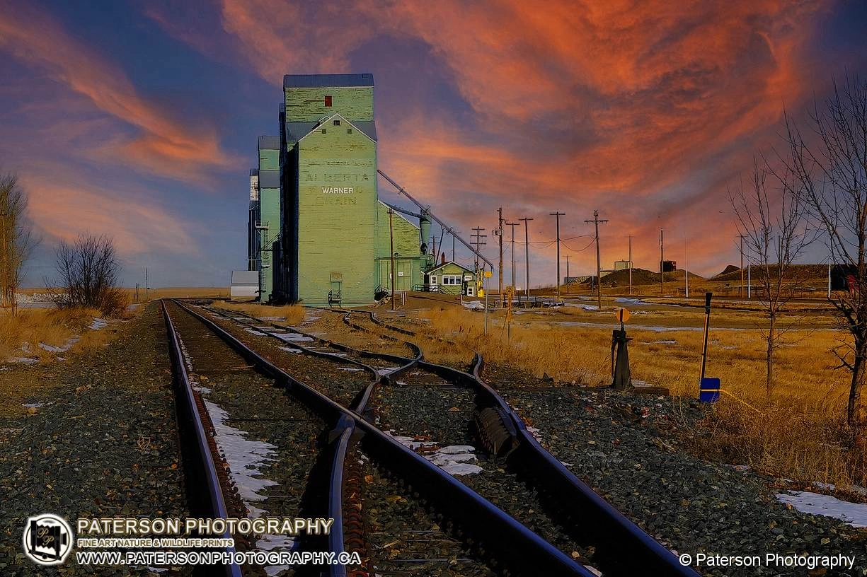 Warner Alberta Grain elevators at sunrise with colorful clouds in the background