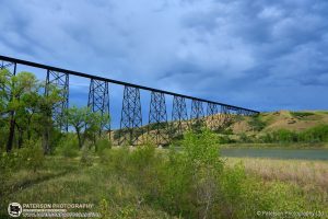 Storm Clouds, rising Oldman river and the Lethbridge Bridge