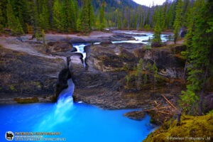 Natural Bridge and turquoise waterfall in Yoho National Park, British Columbia
